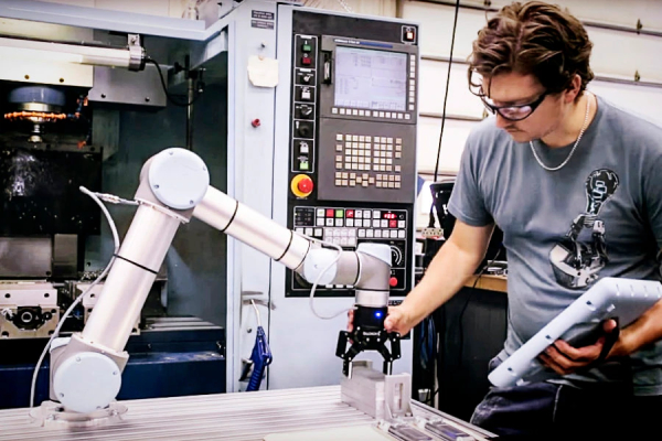 A Man Working With Collaborative Robot In An Industrial Sector.